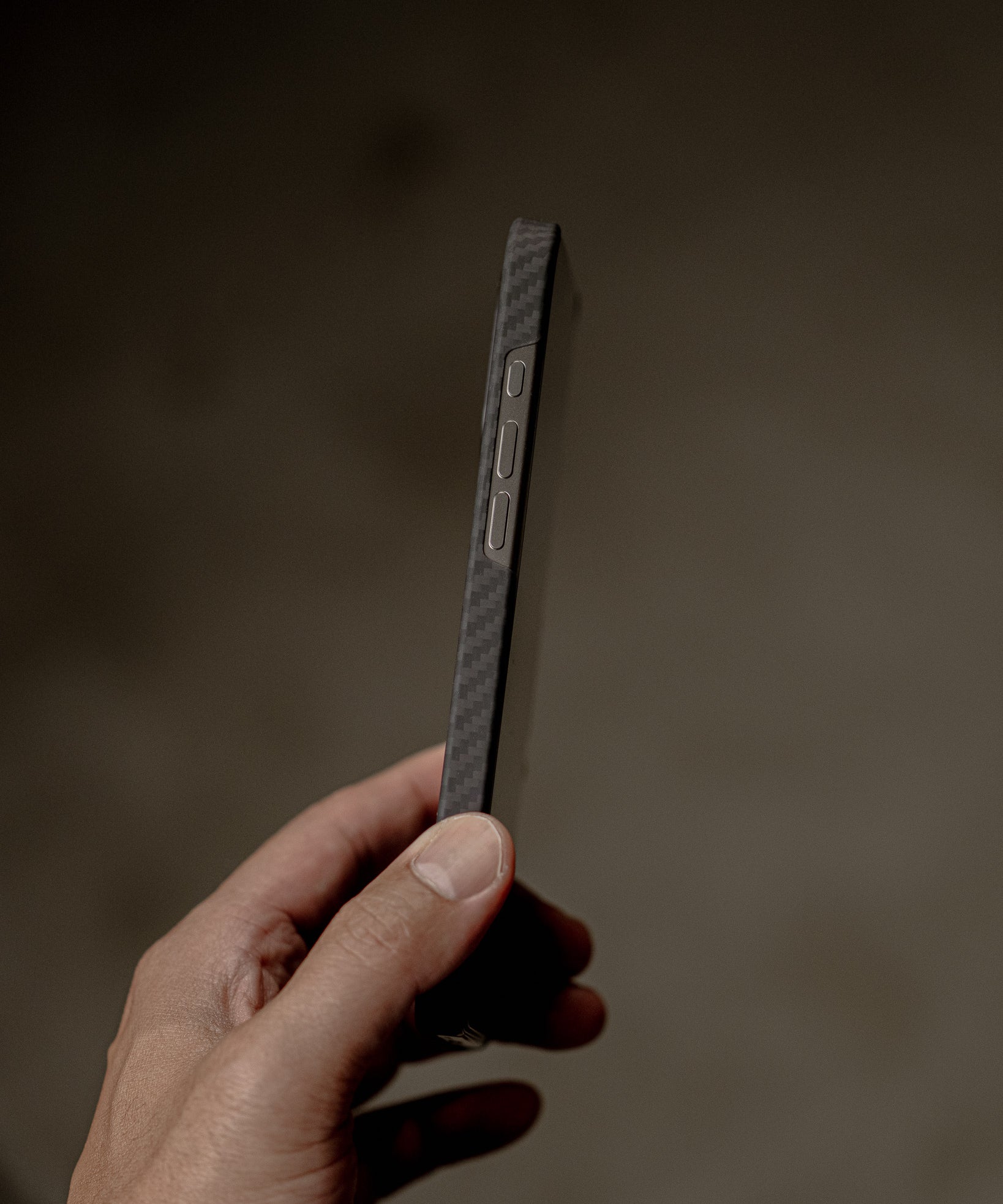 Hand holding a smartphone with a blurred background