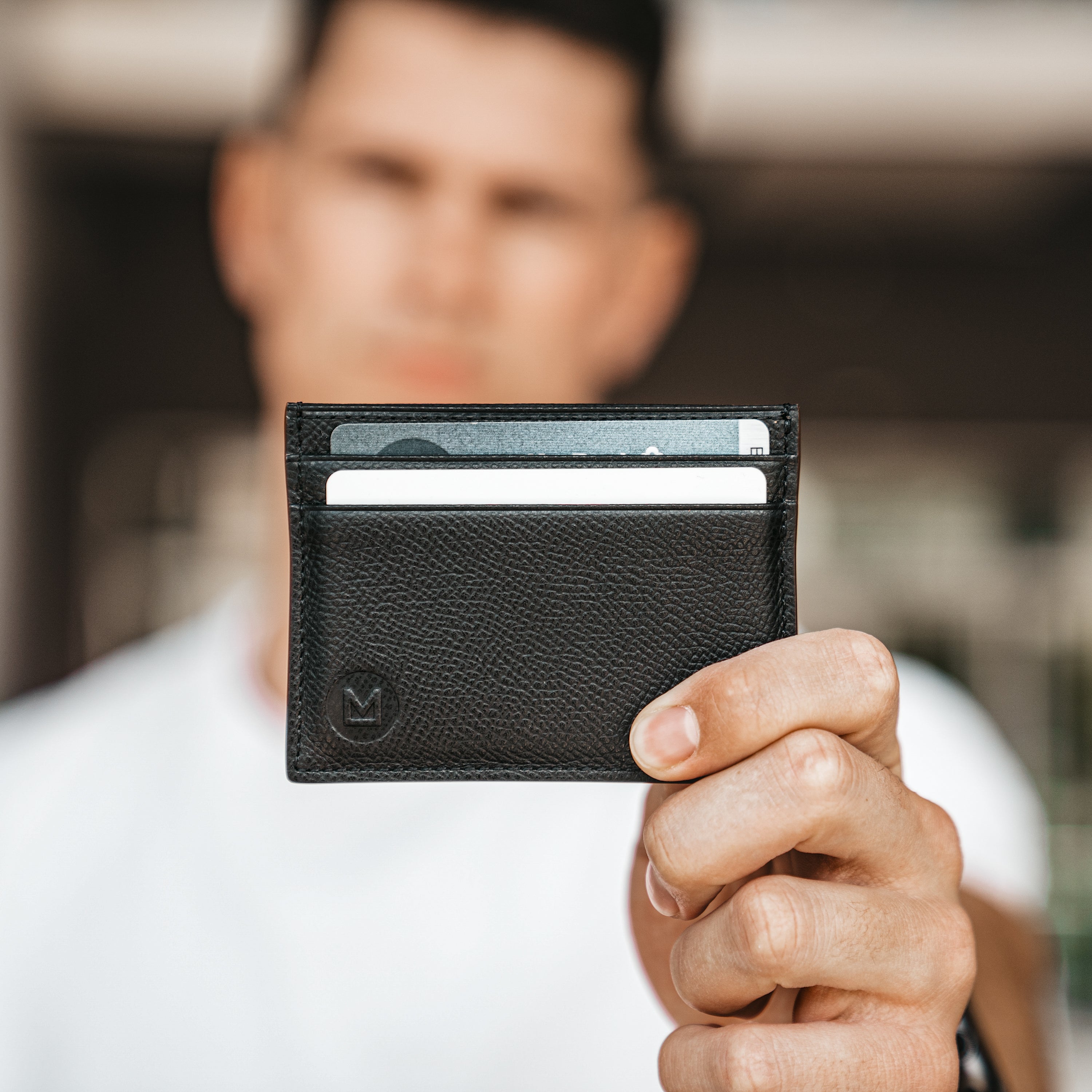 Leather cardholder being held in hand