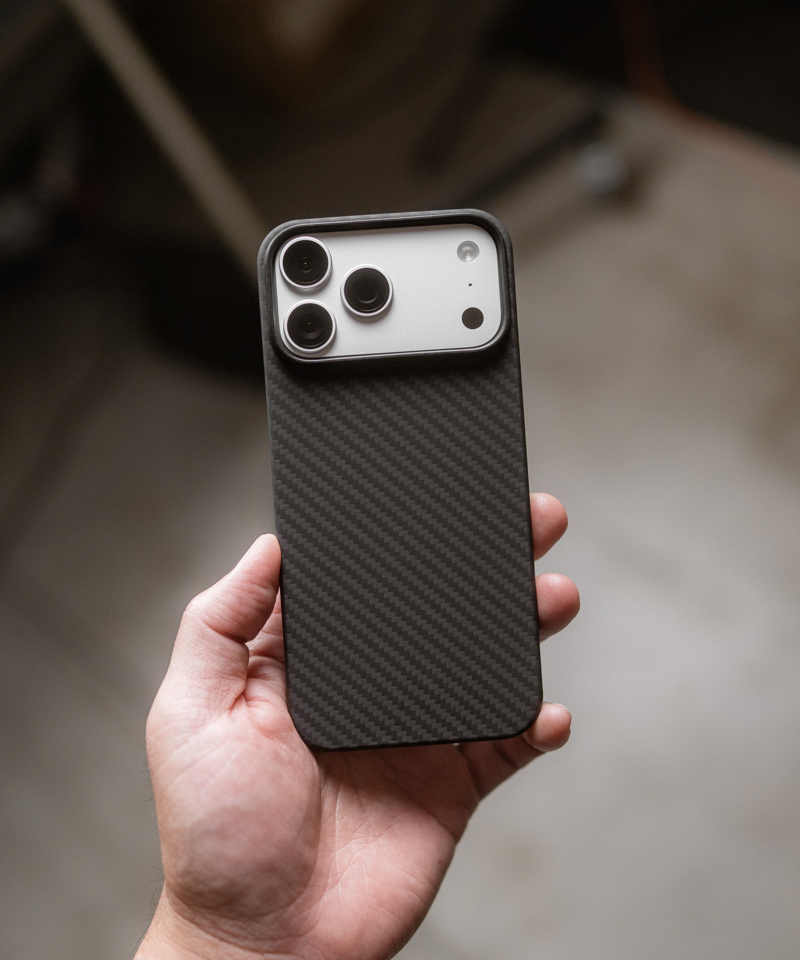 carbon fiber iphone 17 pro max case held in hand