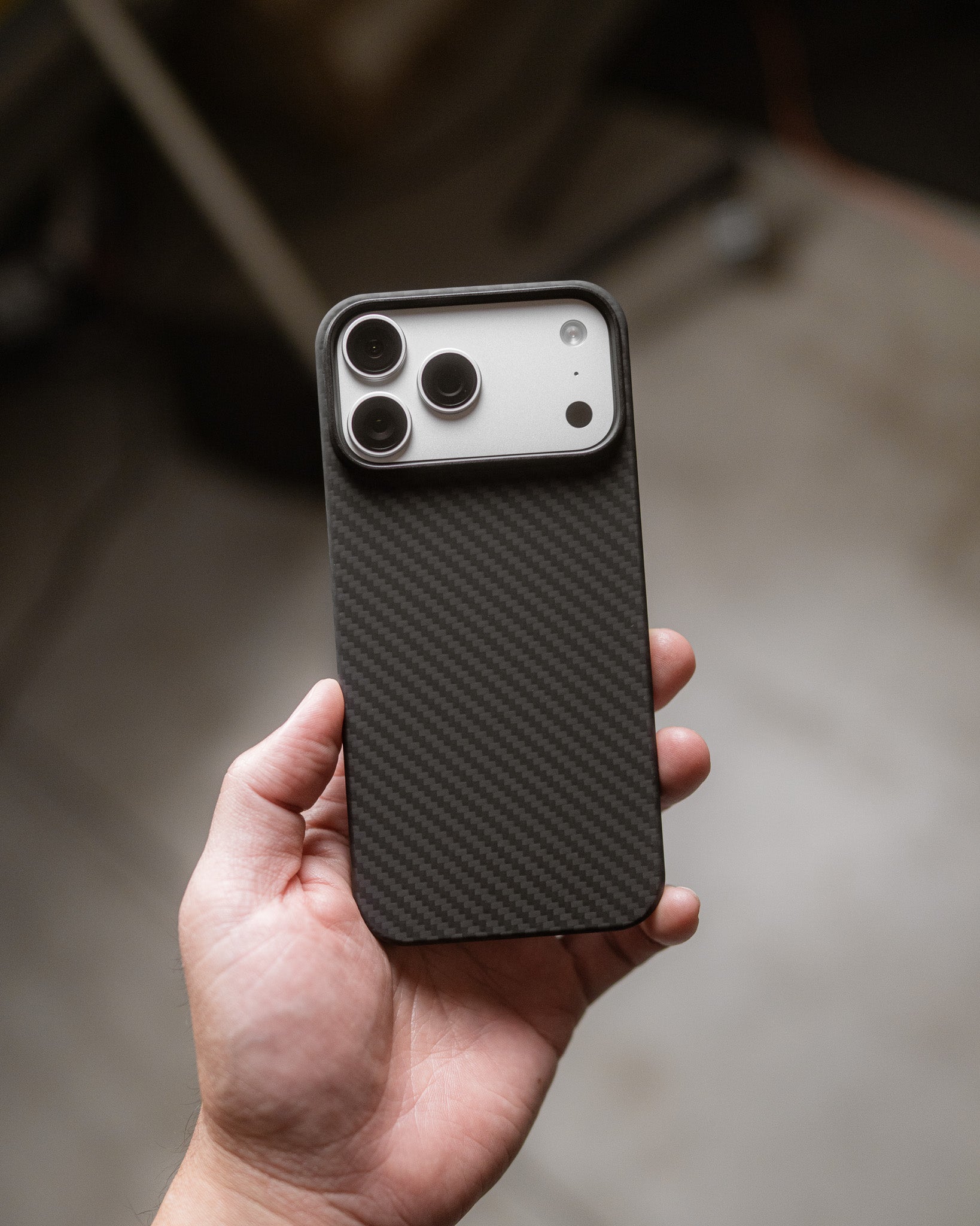 carbon fiber iphone 17 pro max case held in hand